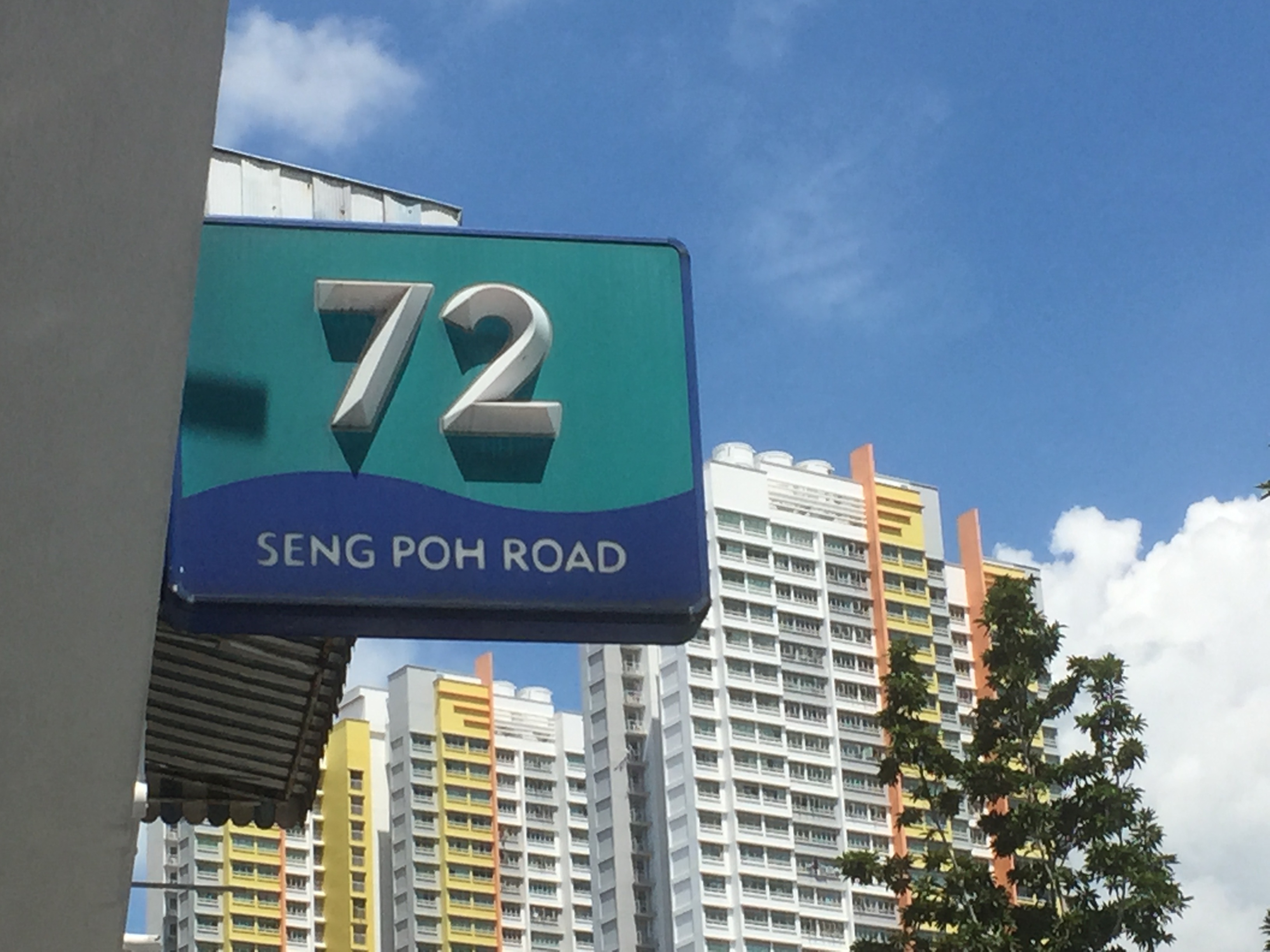 Seng Poh Road sign, with the flats in the background. 